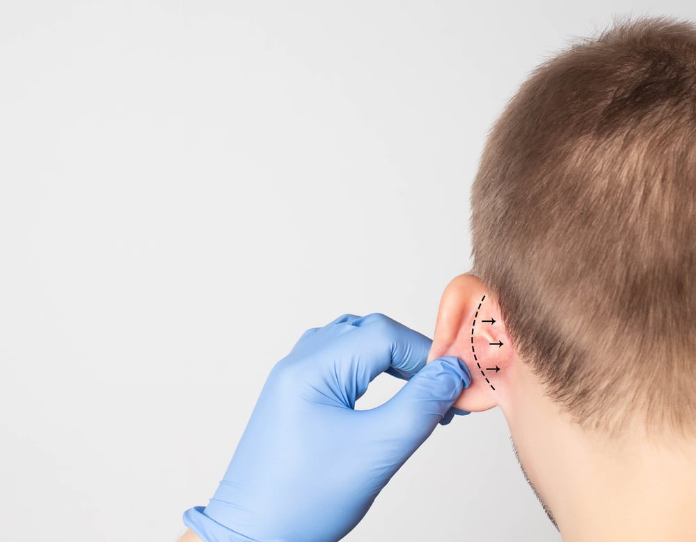 A,Plastic,Surgeon,Doctor,Examines,A,Male,Patient,S,Ear