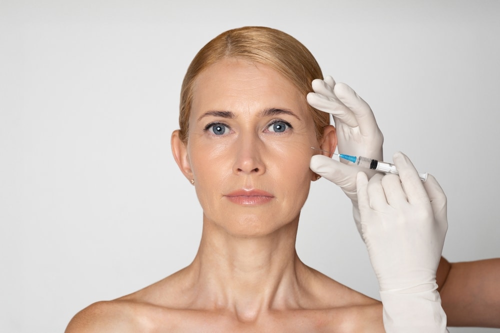 This,Image,Shows,A,Woman,With,Blonde,Hair,Receiving,An