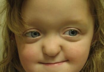 A young girl with blue eyes and long hair.